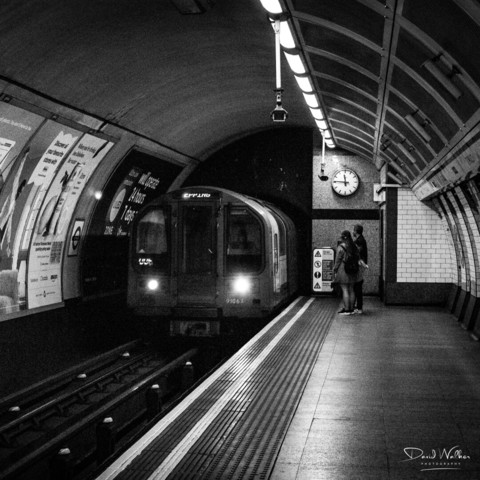 A London Underground train arriving at a station