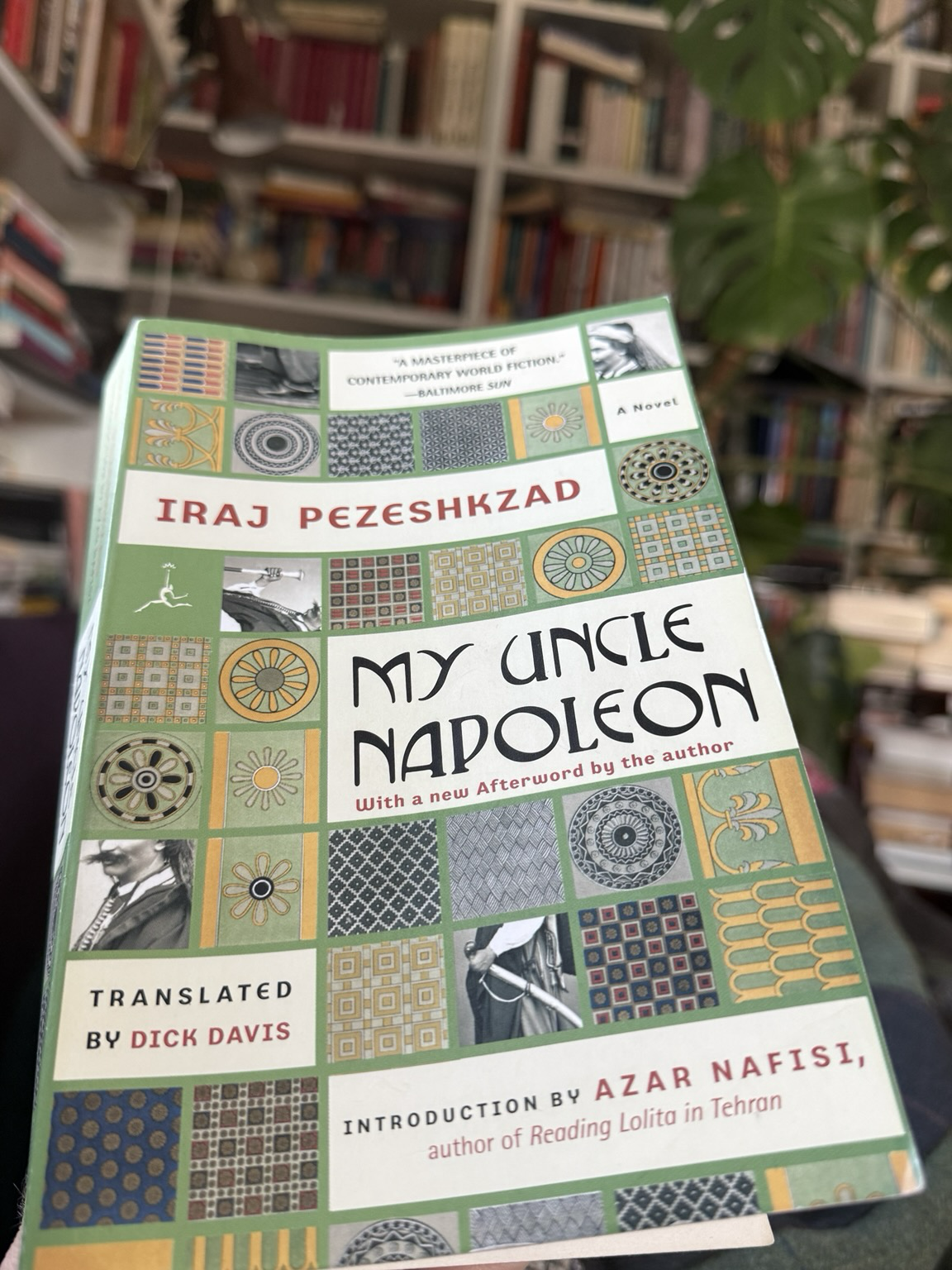 Cover of My Uncle Napoleon. Cover is green with a series of mosaic squares interspersed with cut-outs from a photo of a man with a sword and a very impressive moustache, the title and author, its translator given as Dick Davis and the information that Azar Nafisi has written an introduction.