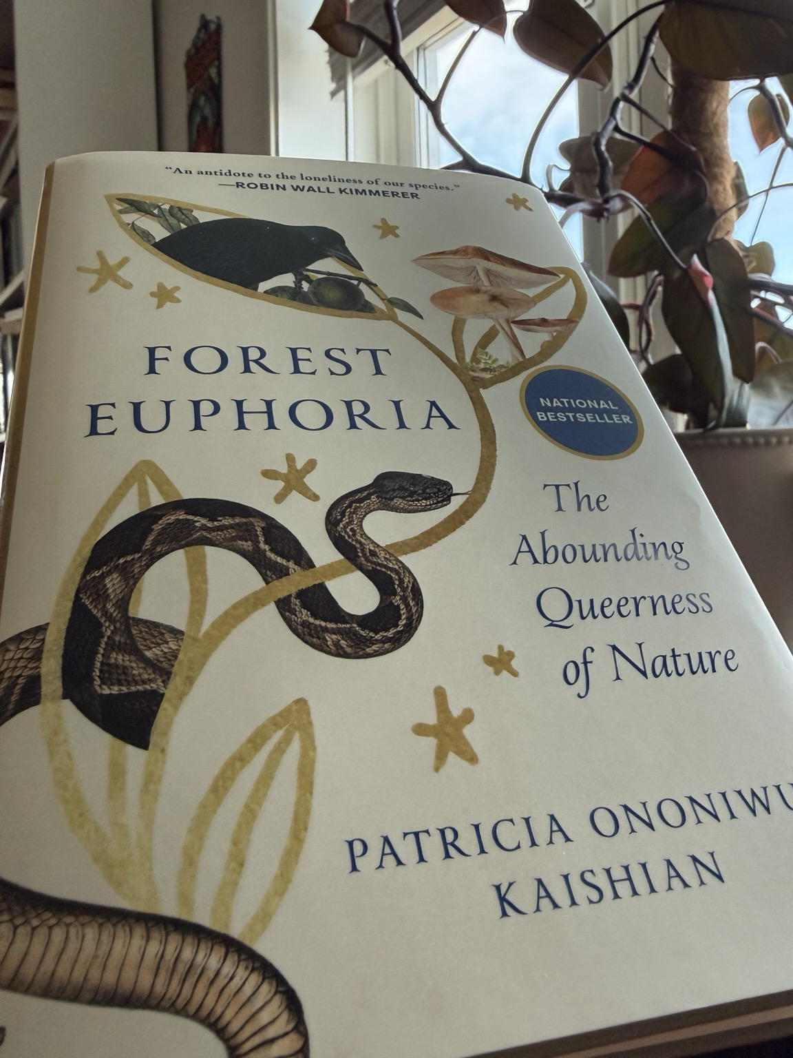 Cover of Forest Euphoria, which has a cream base and blue lettering. Drawings of individual animals in a 19th c naturalist’s style show an earthworm, a snake, mushrooms and a crow.
