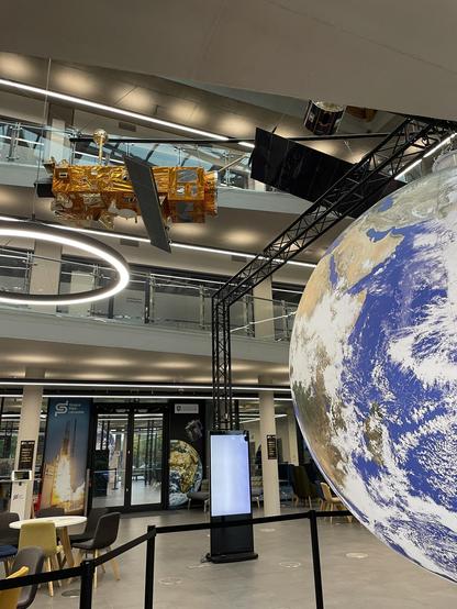Glowing Earth and space equipment in the foyer of the Space Park, Leicester